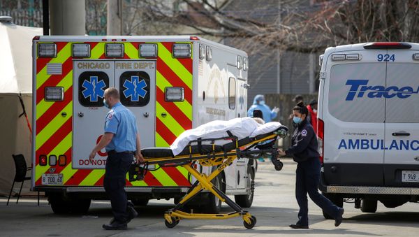 Emergency medical services workers transport a patient during the global outbreak of coronavirus disease (COVID-19) to Roseland Community Hospital in Chicago, Illinois, U.S. April 7, 2020 - Sputnik International