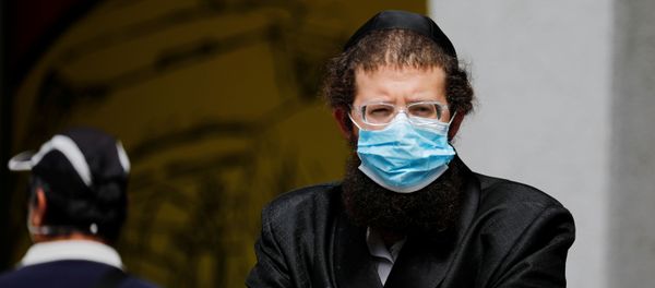 An ultra-Orthodox Jewish man wearing a mask looks on in Bnei Brak, a town badly affected by the coronavirus disease (COVID-19), and which Israel declared a restricted zone due to its high rate of infections, near Tel Aviv, Israel April 5, 2020 An ultra-Orthodox Jewish man wearing a mask looks on in Bnei Brak, a town badly affected by the coronavirus disease (COVID-19), and which Israel declared a restricted zone due to its high rate of infections, near Tel Aviv, Israel April 5, 2020 - Sputnik International