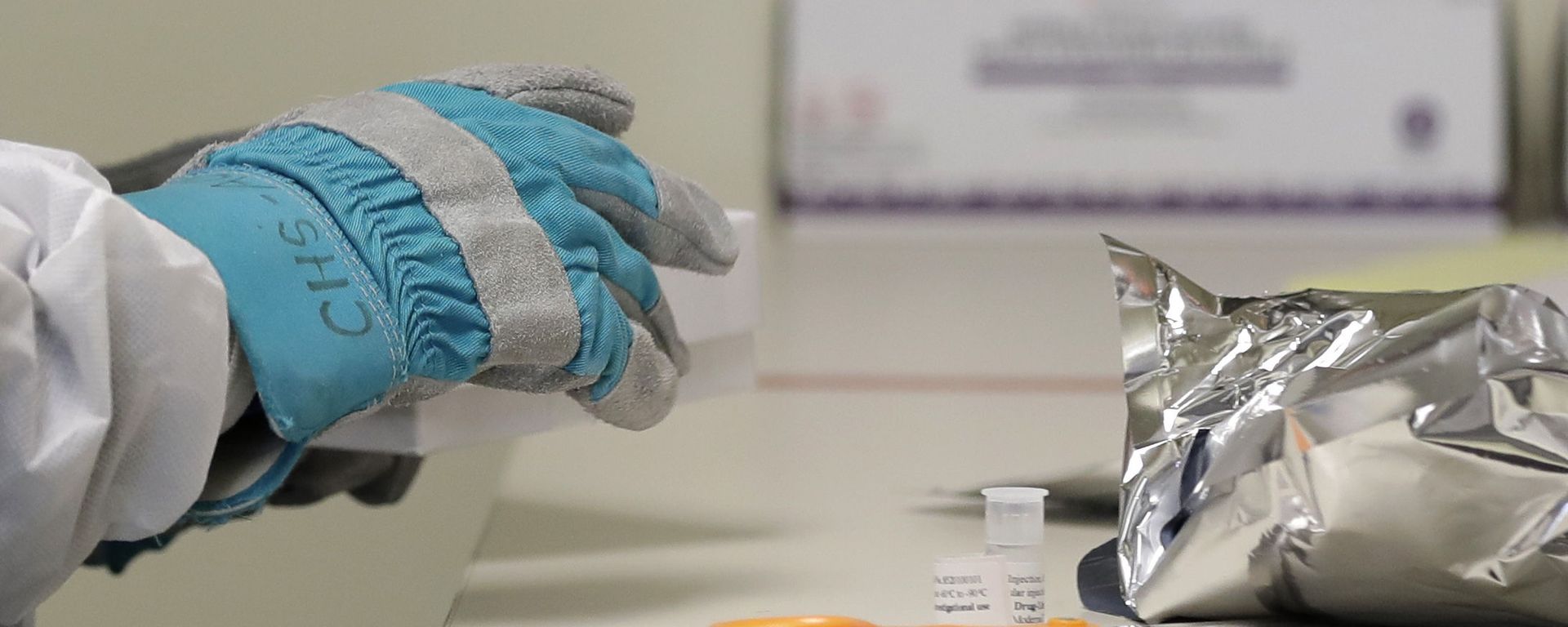 Pharmacist Michael Witte wears heavy gloves as he opens a frozen package of the potential vaccine for COVID-19, the disease caused by the new coronavirus, on the first day of a first-stage safety study clinical trial, Monday, March 16, 2020 Pharmacist Michael Witte wears heavy gloves as he opens a frozen package of the potential vaccine for COVID-19, the disease caused by the new coronavirus, on the first day of a first-stage safety study clinical trial, Monday, March 16, 2020 - Sputnik International, 1920, 21.07.2020
