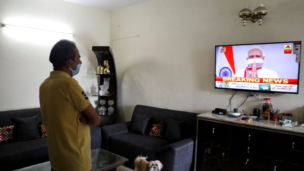 A man watches India's Prime Minister Narendra Modi's address to the nation on a television announcing the extension of a nationwide lockdown till May 3, to limit the spreading of coronavirus disease (COVID-19), in in New Delhi, India, April 14, 2020. REUTERS/Anushree Fadnavis A man watches India's Prime Minister Narendra Modi's address to the nation on a television announcing the extension of a nationwide lockdown till May 3, to limit the spreading of coronavirus disease (COVID-19), in in New Delhi, India, April 14, 2020. REUTERS/Anushree Fadnavis - Sputnik International