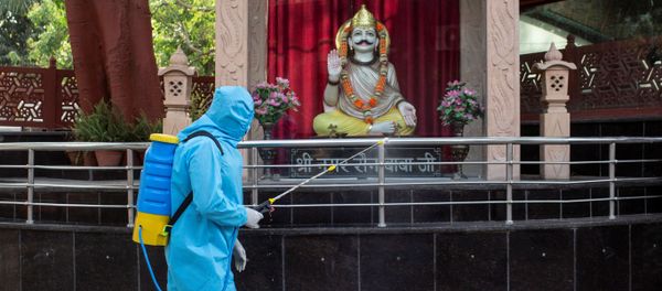 A health worker wearing protective gear sprays disinfectant at a crematorium to slow the spreading of the coronavirus disease (COVID-19), after India extended a nationwide lockdown to contain the disease, in New Delhi, India, April 14, 2020. A health worker wearing protective gear sprays disinfectant at a crematorium to slow the spreading of the coronavirus disease (COVID-19), after India extended a nationwide lockdown to contain the disease, in New Delhi, India, April 14, 2020. - Sputnik International