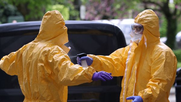 Mortuary employees use disinfectant standing outside an elderly residence following the coronavirus disease (COVID-19) outbreak - Sputnik International