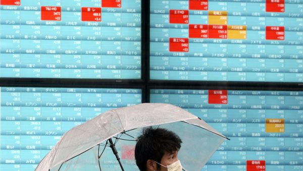 A man with a protective mask stands in the rain in front of an electronic stock board showing Japan's Nikkei 225 index at a securities firm in Tokyo Monday, April 13, 2020 A man with a protective mask stands in the rain in front of an electronic stock board showing Japan's Nikkei 225 index at a securities firm in Tokyo Monday, April 13, 2020 - Sputnik International