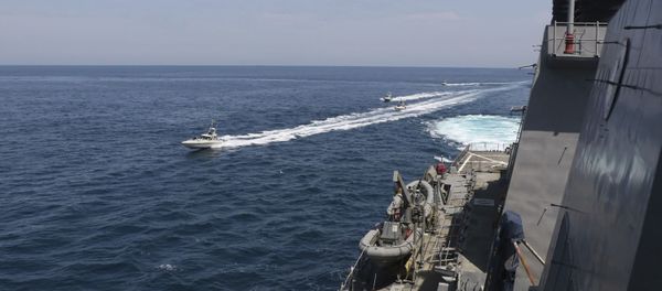 In this Wednesday, April 15, 2020, photo made available by U.S. Navy, Iranian Revolutionary Guard vessels sail close to U.S. military ships in the Persian Gulf near Kuwait In this Wednesday, April 15, 2020, photo made available by U.S. Navy, Iranian Revolutionary Guard vessels sail close to U.S. military ships in the Persian Gulf near Kuwait - Sputnik International