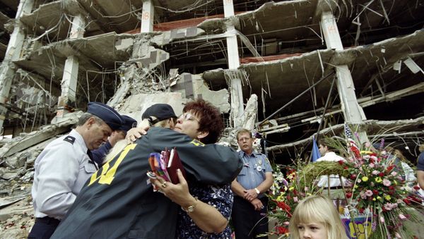 A relative of one of the Oklahoma City victims is embraced by an FBI agent A relative of one of the Oklahoma City victims is embraced by an FBI agent - Sputnik International