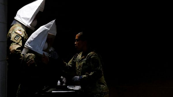 U.S. Army soldiers wear qualitative test fit hoods, filled with sweet or bitter solution to test if their N95 masks fit properly at a military field hospital for non-coronavirus patients inside CenturyLink Field Event Center during the coronavirus disease (COVID-19) outbreak in Seattle, Washington, U.S., April 1, 2020 - Sputnik International