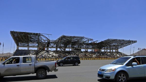Vehicles drive past a popular public square, which was destroyed late 2017 in an airstrike by the Saudi-led coalition, in the capital Sanaa on 9 April 2020. - The Saudi-led coalition began a unilateral ceasefire in Yemen's long war, saying it hoped the initiative to prevent coronavirus in the impoverished country would lead to a wider political solution - Sputnik International