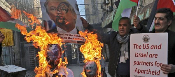 Demonstrators wave Palestinian flags as they burn effigies of US President Donald Trump and Israeli Prime Minister Benjamin Netanyahu during a protest against Trump's proposed Israeli-Palestinian peace plan, dubbed as the deal of the century, outside an Israeli checkpoint in the flashpoint city of Hebron in the occupied West Bank on February 28, 2020.  - Sputnik International