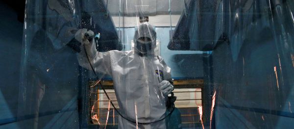 A worker wearing a protective suit disinfects the interior of a passenger train after it was converted into an isolation facility amid concerns about the spread of coronavirus disease (COVID-19), on the outskirts of Kolkata, India, April 6, 2020. A worker wearing a protective suit disinfects the interior of a passenger train after it was converted into an isolation facility amid concerns about the spread of coronavirus disease (COVID-19), on the outskirts of Kolkata, India, April 6, 2020. - Sputnik International