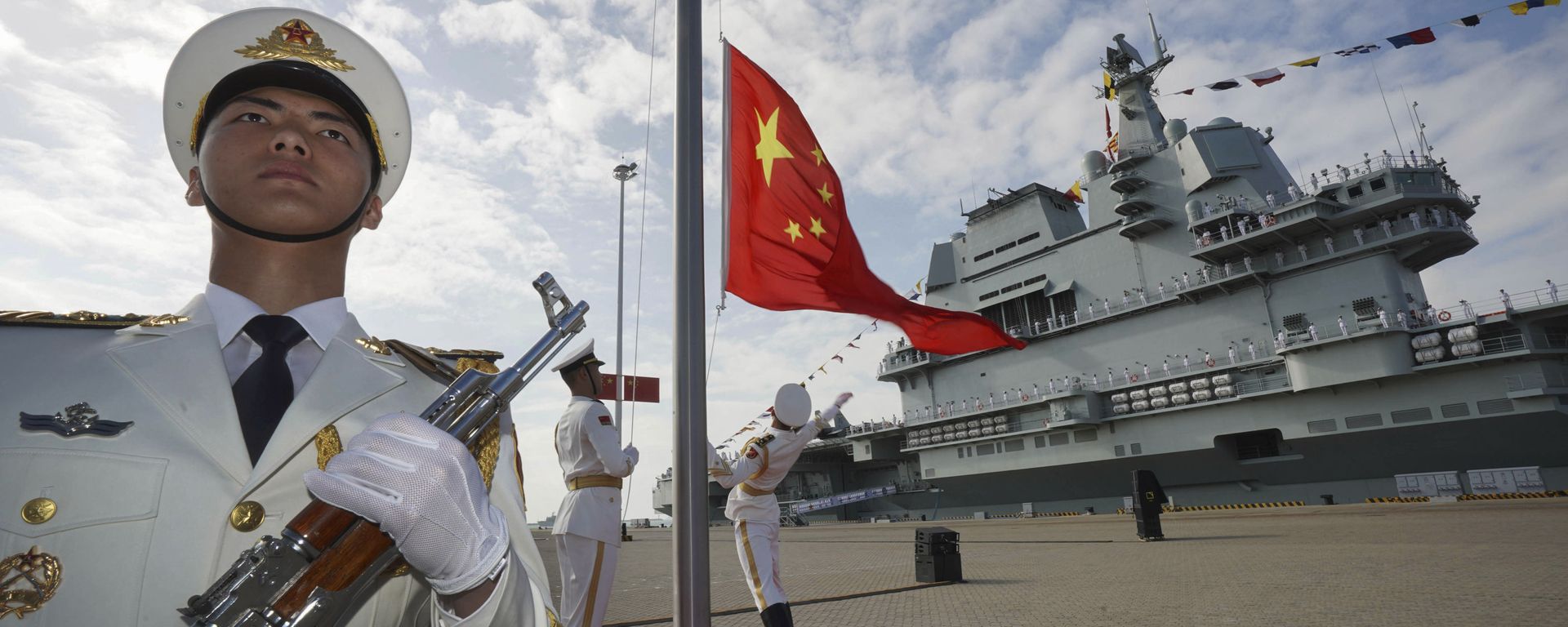 In this photo taken Dec. 17, 2019 and released Dec. 27, 2019 by Xinhua News Agency, Chinese honor guard raise the Chinese flag during the commissioning ceremony of China's Shandong aircraft carrier at a naval port in Sanya, south China's Hainan Province In this photo taken Dec. 17, 2019 and released Dec. 27, 2019 by Xinhua News Agency, Chinese honor guard raise the Chinese flag during the commissioning ceremony of China's Shandong aircraft carrier at a naval port in Sanya, south China's Hainan Province - Sputnik International, 1920, 25.10.2023