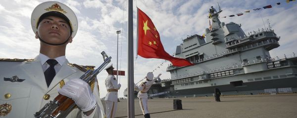 In this photo taken Dec. 17, 2019 and released Dec. 27, 2019 by Xinhua News Agency, Chinese honor guard raise the Chinese flag during the commissioning ceremony of China's Shandong aircraft carrier at a naval port in Sanya, south China's Hainan Province In this photo taken Dec. 17, 2019 and released Dec. 27, 2019 by Xinhua News Agency, Chinese honor guard raise the Chinese flag during the commissioning ceremony of China's Shandong aircraft carrier at a naval port in Sanya, south China's Hainan Province - Sputnik International