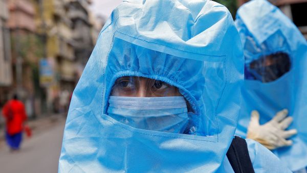 Indian health workers wearing protective gear check people to find out if they have developed any COVID-19 symptoms - Sputnik International
