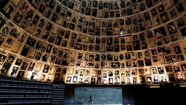 A security personnel walks at the Hall of Names at the Yad Vashem World Holocaust Remembrance Center in Jerusalem, before beginning of Israel's annual Holocaust Remembrance Day, as the centre is closed following the coronavirus disease (COVID-19) restrictions around the country, April 20, 2020 - Sputnik International