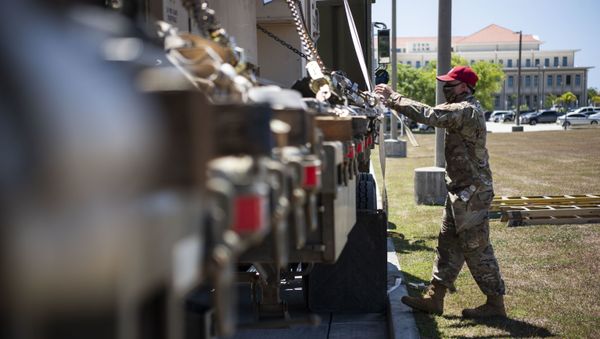 An Airman from the 554th RED HORSE Squadron prepares to unload medical supplies for the Expeditionary Medical Support System facility April 13, 2020, at U.S. Naval Hospital Guam. The EMEDS facicilty will be used as part of the effort to help combat the COVID-19 pandmeic happening on island - Sputnik International