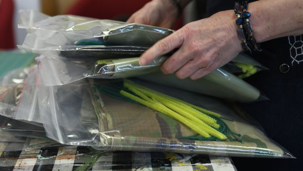 An Arts and Crafts center employee stacks numerous packs of protective mask kits at Royal Air Force Lakenheath, England, April 8, 2020. An Arts and Crafts center employee stacks numerous packs of protective mask kits at Royal Air Force Lakenheath, England, April 8, 2020. - Sputnik International