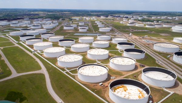 Crude oil storage tanks are seen in an aerial photograph at the Cushing oil hub in Cushing, Oklahoma, U.S. April 21, 2020. - Sputnik International
