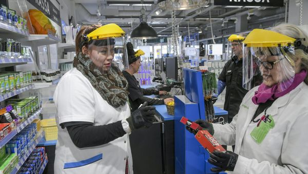 Workers wearing protective clothing are seen, as the spread of the coronavirus disease (COVID-19) continues, in Vantaa, Finland April 1, 2020 - Sputnik International