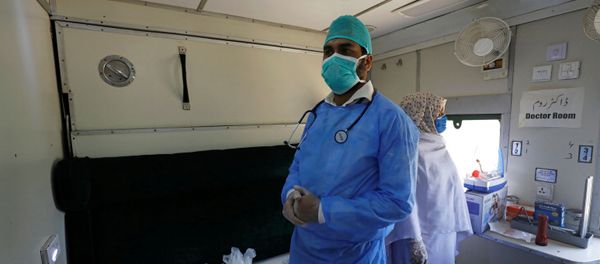 A doctor and nurse wear protective masks as they stand in a passenger train's car, after the government turned it into a hospital and quarantine center following the outbreak of coronavirus disease (COVID-19), in Karachi, Pakistan, March 31, 2020 - Sputnik International