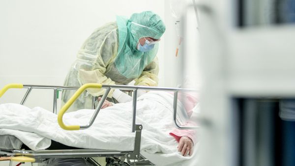 A nurse in protective gear takes a blood sample of a patient potentially infected with coronavirus disease (COVID-19) - Sputnik International