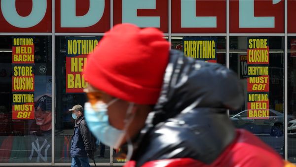 A man wearing a mask rides past a Modell's store that is closed, as retail sales suffer record drop during the outbreak of the coronavirus disease (COVID-19) in New York City, New York, U.S., April 15, 2020.  - Sputnik International
