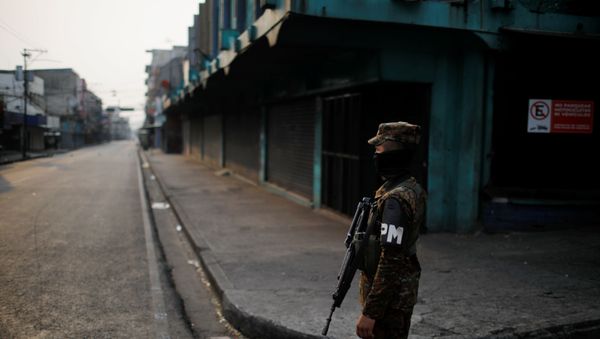 A military police officer stands close to a checkpoint during a police and army joint operation as part of security measures to keep people out of the city downtown markets during a quarantine throughout the country to curb the spread of the coronavirus disease (COVID-19), in San Salvador, El Salvador April 22, 2020. A military police officer stands close to a checkpoint during a police and army joint operation as part of security measures to keep people out of the city downtown markets during a quarantine throughout the country to curb the spread of the coronavirus disease (COVID-19), in San Salvador, El Salvador April 22, 2020. - Sputnik International