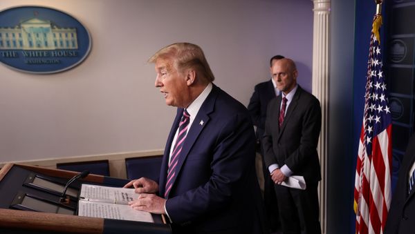 U.S. President Donald Trump leads the daily coronavirus task force briefing as Food and Drug Administration (FDA) Commissioner Dr. Stephen Hahn listens at the White House in Washington, U.S., April 24, 2020 - Sputnik International