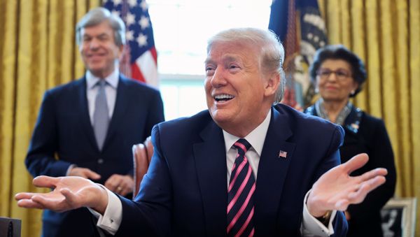U.S. President Donald Trump speaks to reporters as Senator Roy Blunt (R-MO) and Small Business Administration (SBA) Administrator Jovita Carranza look on during a signing ceremony for the Paycheck Protection Program and Health Care Enhancement Act, approving additional coronavirus disease (COVID-19) relief for the U.S. economy and hospitals treating people sickened by the pandemic, in the Oval Office at the White House in Washington, U.S., April 24, 2020 - Sputnik International