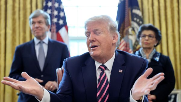U.S. President Donald Trump speaks to reporters as Senator Roy Blunt (R-MO) and Small Business Administration (SBA) Administrator Jovita Carranza look on during a signing ceremony for the Paycheck Protection Program and Health Care Enhancement Act, approving additional coronavirus disease (COVID-19) relief for the U.S. economy and hospitals treating people sickened by the pandemic, in the Oval Office at the White House in Washington, U.S., April 24, 2020 - Sputnik International