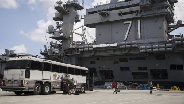 Sailors assigned to the aircraft carrier USS Theodore Roosevelt (CVN 71) prepare to embark the ship after weeks of cleaning and essential watch standing - Sputnik International