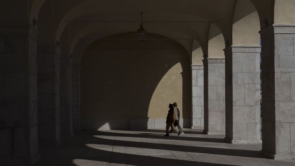 Two women walk along a deserted plaza in Nice, southern France, Sunday, March 15, 2020. French Prime Minister Edouard Philippe announced that France is shutting down all restaurants, cafes, cinemas and non-essential retail shops, starting Sunday, to combat the accelerated spread of the virus in the country. For most people, the new coronavirus causes only mild or moderate symptoms. - Sputnik International