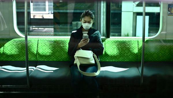 A woman with a phone in Tokyo A woman with a phone in Tokyo - Sputnik International