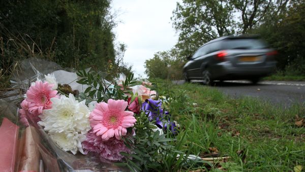 Floral tributes lay on the roadside near RAF Croughton in Northamptonshire, central England on October 10, 2019, at the spot where British motorcyclist Harry Dunn was killed as he travelled along the B4031 on August 27. - Dunn was killed on August 27 when his motorbike collided with a car near a Royal Air Force base in Northamptonshire in central England, which is used by the US military as a communications hub. - Sputnik International