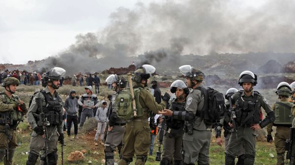 Israeli soldiers and borderguards stand guard during a Palestinian demonstration against Israeli settlements in the village of Qusra, in the Israeli occupied West Bank on March 2, 2020. Israeli soldiers and borderguards stand guard during a Palestinian demonstration against Israeli settlements in the village of Qusra, in the Israeli occupied West Bank on March 2, 2020. - Sputnik International