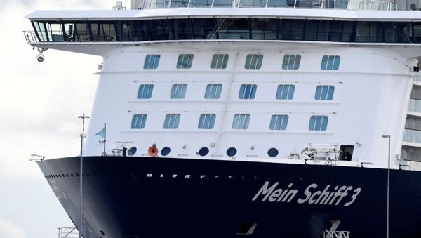 Cruise ship Mein Schiff 3 sits in the harbour with nearly 3000 travel agency TUI staff members quarantined onboard, according to local media, during the coronavirus disease (COVID-19) spread, in Cuxhaven, Germany 2 May 2020. - Sputnik International