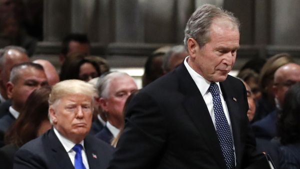 Former President George W. Bush walks past President Donald Trump to speak at the State Funeral for his father, former President George H.W. Bush, at the State Funeral at the National Cathedral, 5 December 2018, in Washington - Sputnik International