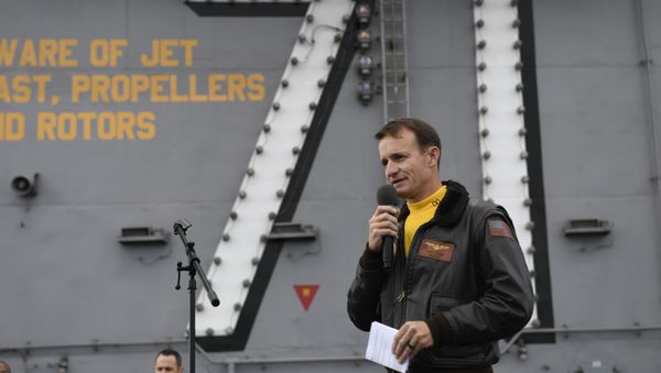 Capt. Brett Crozier, commanding officer of the aircraft carrier USS Theodore Roosevelt (CVN 71), addresses the crew during an all-hands call on the ship’s flight deck Capt. Brett Crozier, commanding officer of the aircraft carrier USS Theodore Roosevelt (CVN 71), addresses the crew during an all-hands call on the ship’s flight deck - Sputnik International