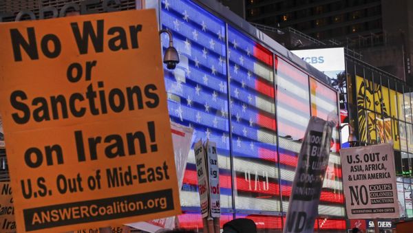 Protesters gather in Times Square Wednesday, Jan. 8, 2020, in New York. The U.S. and Iran stepped back from the brink of possible war Wednesday, as President Donald Trump indicated he would not respond militarily after no one was harmed in Iran's missile strike on two Iraqi bases housing U.S. troops. - Sputnik International