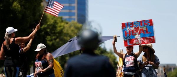 Demonstrators rally in front of the California State Capital building during a protest calling for the reopening of California, amid the outbreak of the coronavirus disease (COVID-19), in Sacramento, California, U.S. May 7, 2020. Demonstrators rally in front of the California State Capital building during a protest calling for the reopening of California, amid the outbreak of the coronavirus disease (COVID-19), in Sacramento, California, U.S. May 7, 2020. - Sputnik International