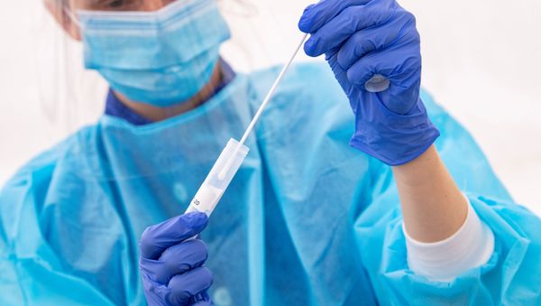 A medical staff wearing protective gear administers tests for the coronavirus disease (COVID-19) at a test facility, in a tent outside the Skane University Hospital in Lund, Sweden. - Sputnik International