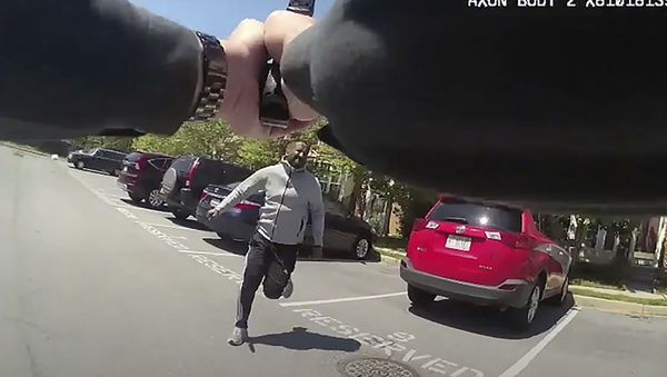 In this frame grab from body camera video provided by the Montgomery County Department of Police, taken Thursday, May 7, 2020, Montgomery County Police Sgt. David Cohen aims and shoots Finan H. Berhe, as Berhe, holding a knife, charges at Cohen, after the officer had ordered Berhe to drop the knife and get down on the ground, in the White Oak area of Montgomery County, Md. Berhe died at a hospital, police said. No officers were injured. - Sputnik International