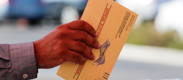 An election worker places a mail-in ballot into an election box at a drive-through drop off location at the Registrar of Voters in San Diego, California, U.S. November 5, 2018 An election worker places a mail-in ballot into an election box at a drive-through drop off location at the Registrar of Voters in San Diego, California, U.S. November 5, 2018 - Sputnik International