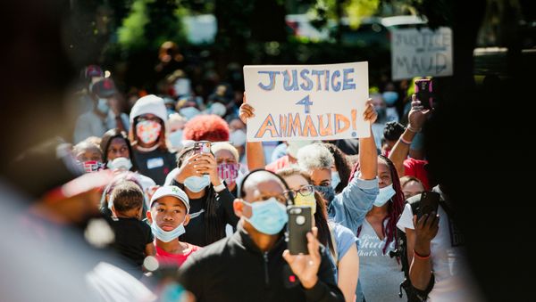 Supporters of the Georgia NAACP (National Association for the Advancement of Colored People) wearing protective masks protest after the death in February of Ahmaud Arbery, an unarmed young black man shot after being chased by a white former law enforcement officer and his son, at the Glynn County Courthouse in Brunswick, Georgia, U.S., May 8, 2020 - Sputnik International