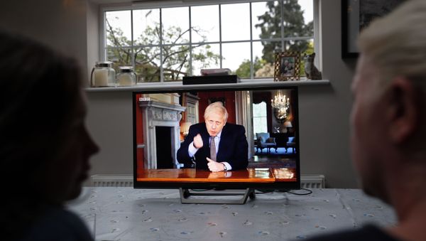 A family gather around the television to watch Britain's Prime Minister Boris Johnson give a televised message to the nation in Hartley Wintney, west of London on May 10, 2020, as the government sets out it's roadmap to ease the national lockdown due to the novel coronavirus COVID-19 pandemic. A family gather around the television to watch Britain's Prime Minister Boris Johnson give a televised message to the nation in Hartley Wintney, west of London on May 10, 2020, as the government sets out it's roadmap to ease the national lockdown due to the novel coronavirus COVID-19 pandemic. - Sputnik International