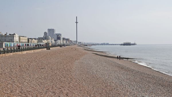 The beaches are nearly empty on a warm and sunny day after the coronavirus outbreak and lockdown in Brighton, England, Saturday, April 11, 2020. - Sputnik International