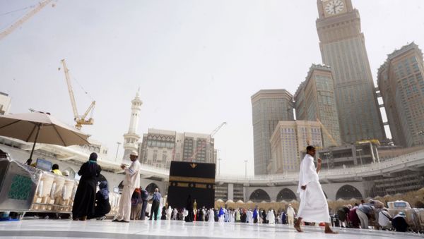 A small number of pilgrims circumambulate around the Kaaba, the cubic building at the Grand Mosque, during the minor pilgrimage, known as Umrah, in the Muslim holy city of Mecca, Saudi Arabia, Monday, March 2, 2020 - Sputnik International