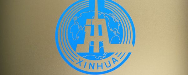 Logo of China's Xinhua News Agency is seen on a glass partition at the agency's newsroom in Beijing. File photo. - Sputnik International