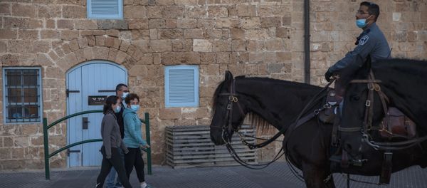 People wear protective face masks amid concerns over the country's coronavirus outbreak as they walk in the city of Jaffa, near Tel Aviv, Israel, 9 May 2020. Israeli authorities have recently begun loosening the restrictions of the coronavirus lockdown, the easing has brought people out of their homes to enjoy the outdoors. People wear protective face masks amid concerns over the country's coronavirus outbreak as they walk in the city of Jaffa, near Tel Aviv, Israel, 9 May 2020. Israeli authorities have recently begun loosening the restrictions of the coronavirus lockdown, the easing has brought people out of their homes to enjoy the outdoors. - Sputnik International