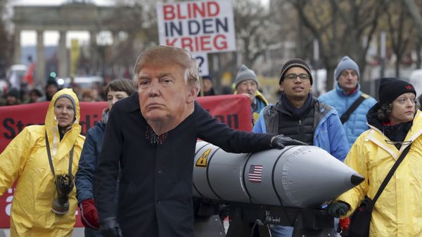 An anti-war protester wears a mask showing US President Donald Trump in Berlin, Germany, Saturday, Nov. 18, 2017 during a demonstration  against nuclear weapons near the Brandenburg Gate - Sputnik International