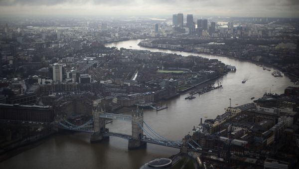 Tower Bridge, centre, and the Canary Wharf business district in the distance as the River Thames flows through London, are seen through a window during the official opening of The View viewing platform at the 95-storey Shard skyscraper in London, Friday, Feb. 1, 2013 Tower Bridge, centre, and the Canary Wharf business district in the distance as the River Thames flows through London, are seen through a window during the official opening of The View viewing platform at the 95-storey Shard skyscraper in London, Friday, Feb. 1, 2013 - Sputnik International