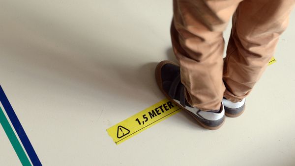 A schoolchild stands on a sign to respect social distancing in a primary school during its reopening as a small part of Belgian children head back to their schools with new rules and social distancing during the outbreak of the coronavirus disease (COVID-19) in Brussels, Belgium May 15, 2020 - Sputnik International